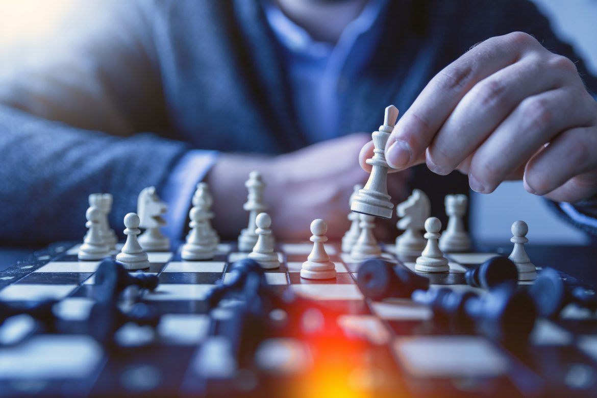 jeshoots-com-fzOITuS1DIQ-unsplash Man playing chess as a representation of formulating collections strategy