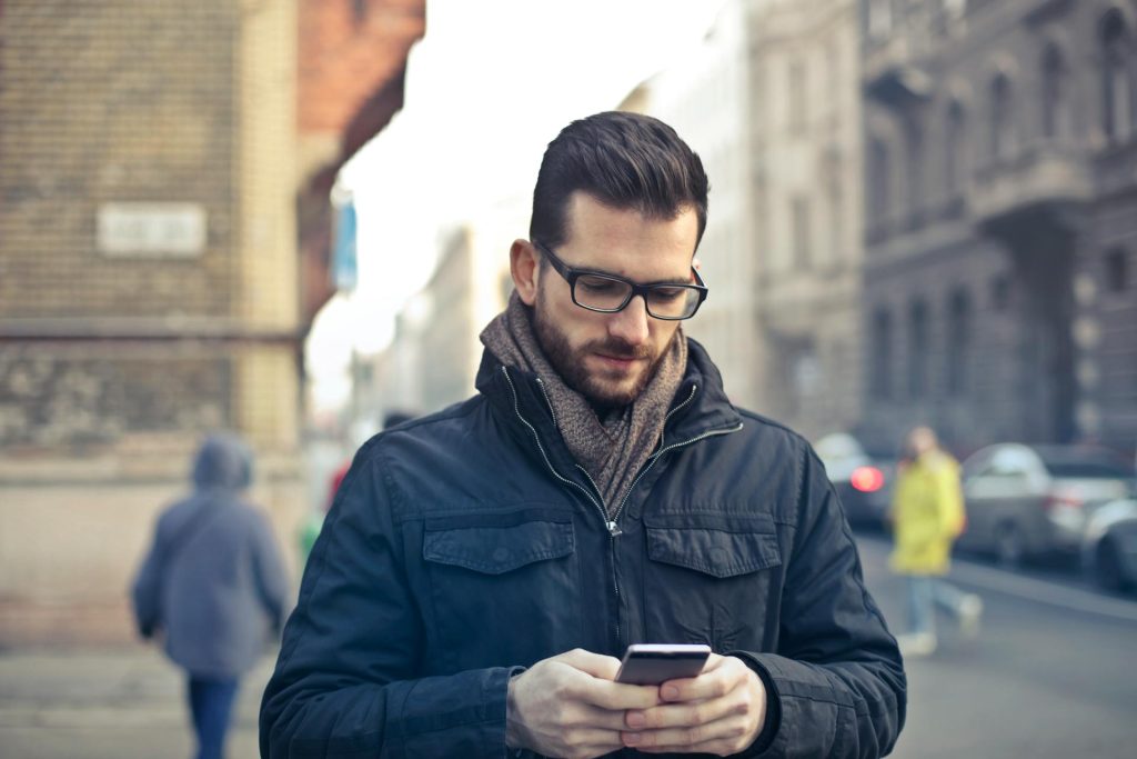 man using phone to navigate omnichannel collections process
