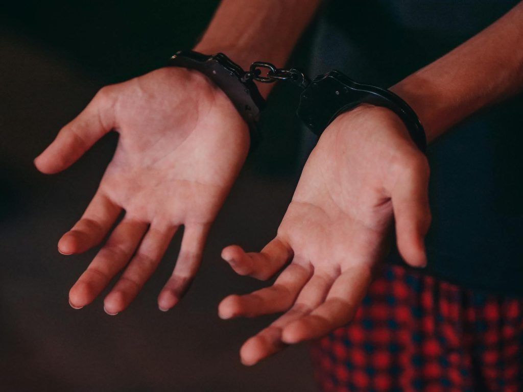 person in handcuffs after committing property crime