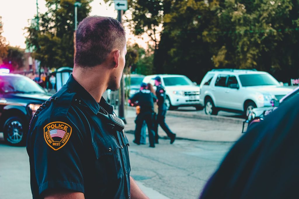 police officer watching arrest of a suspect whose identity was verified using social media images