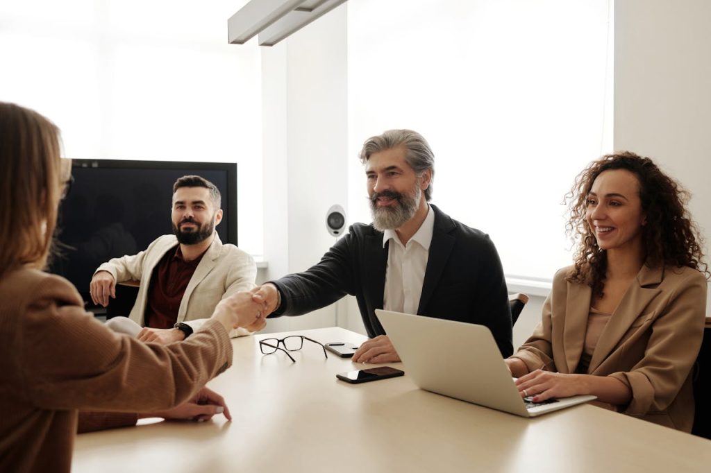 group of attorneys greeting new client after successful personal injury firm marketing campaign